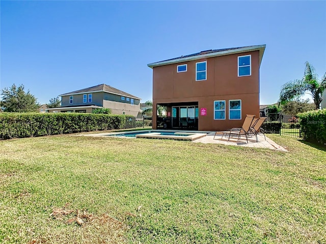 back of house featuring a fenced in pool, a patio, and a yard