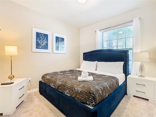 bedroom featuring light colored carpet