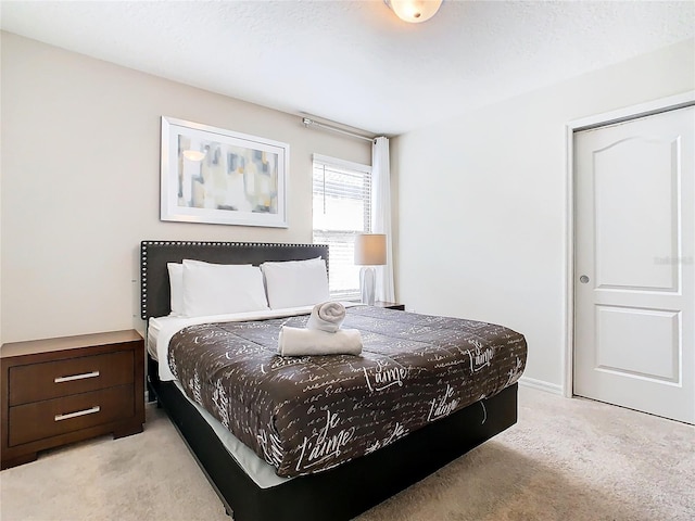 bedroom featuring light carpet