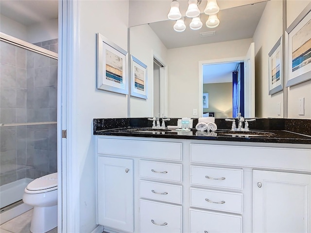 bathroom featuring vanity, toilet, and walk in shower