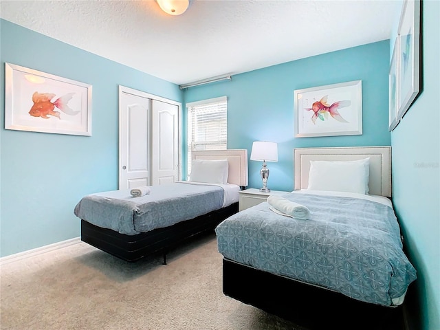 carpeted bedroom featuring a closet and a textured ceiling