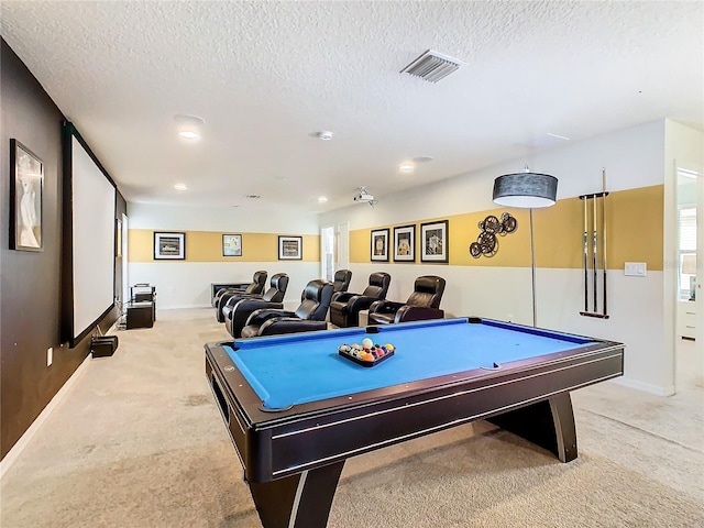 game room featuring pool table, a textured ceiling, and light colored carpet