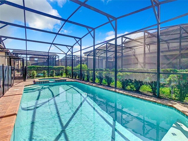 view of swimming pool with glass enclosure