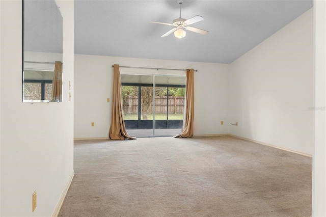 carpeted spare room featuring lofted ceiling and ceiling fan