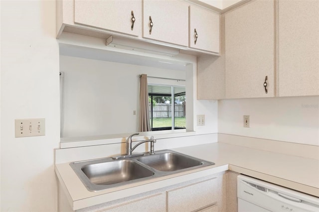 kitchen with dishwasher, white cabinetry, and sink