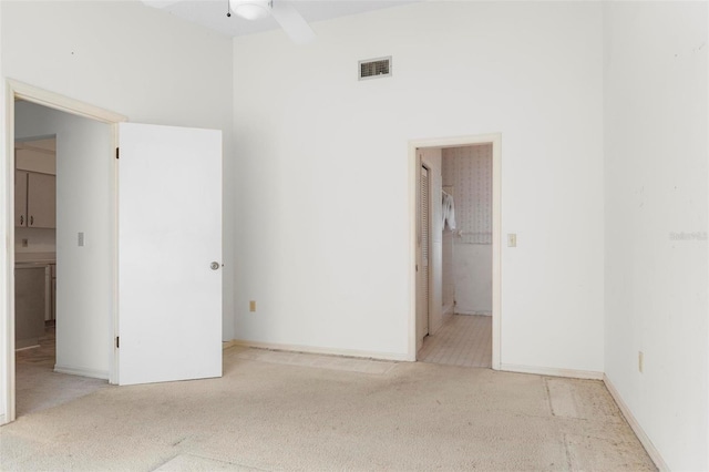 unfurnished room featuring ceiling fan and light carpet