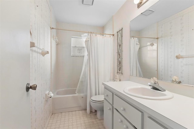 full bathroom featuring vanity, toilet, and shower / tub combo with curtain