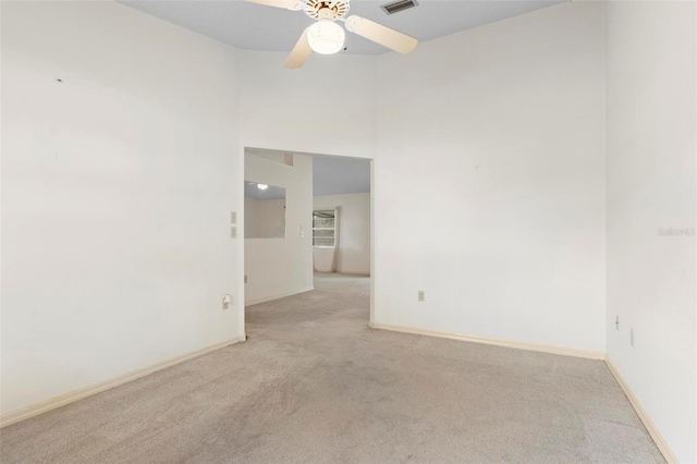 carpeted spare room with ceiling fan