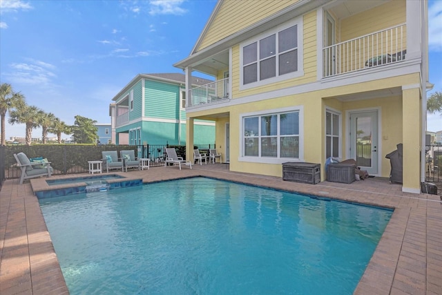 view of pool with an in ground hot tub and a patio