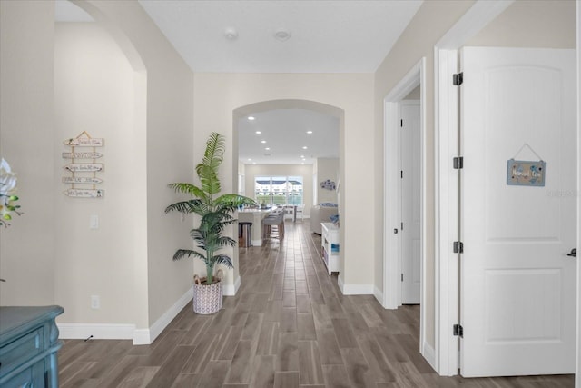 hall with hardwood / wood-style flooring