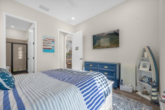 bedroom with dark hardwood / wood-style flooring