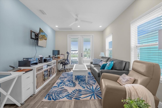 living room featuring french doors and ceiling fan