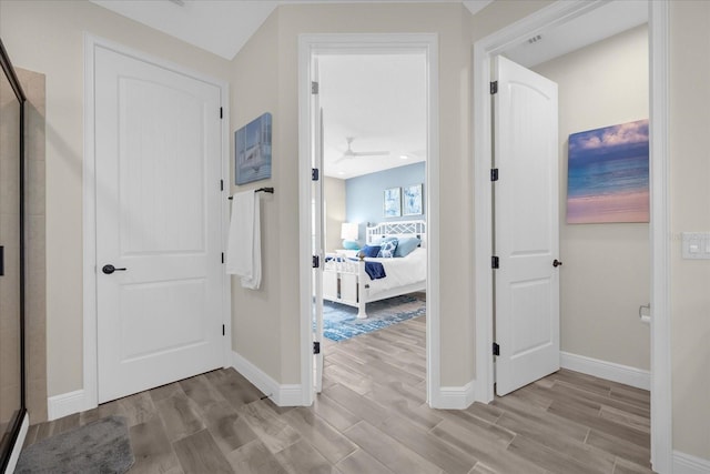 corridor with light hardwood / wood-style flooring