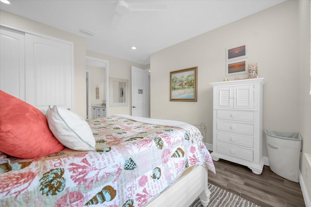 bedroom with dark hardwood / wood-style flooring, a closet, and ceiling fan