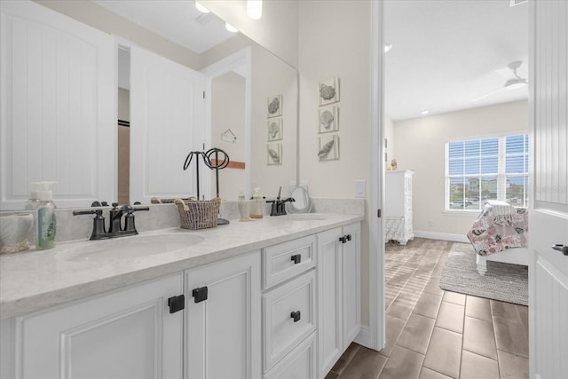 bathroom featuring tile patterned floors, vanity, and ceiling fan