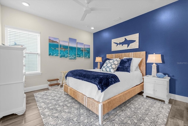 bedroom with ceiling fan and light wood-type flooring