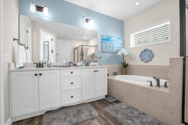 bathroom featuring vanity and independent shower and bath