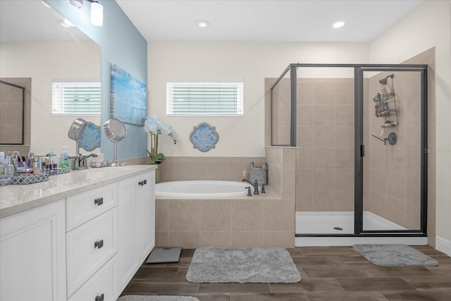 bathroom featuring a wealth of natural light, vanity, and independent shower and bath