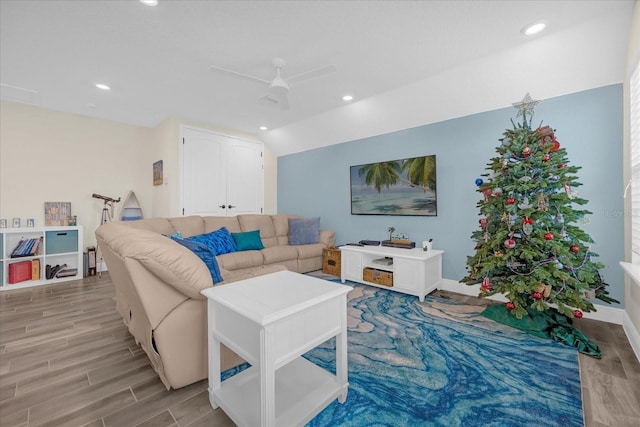 living room featuring ceiling fan and vaulted ceiling