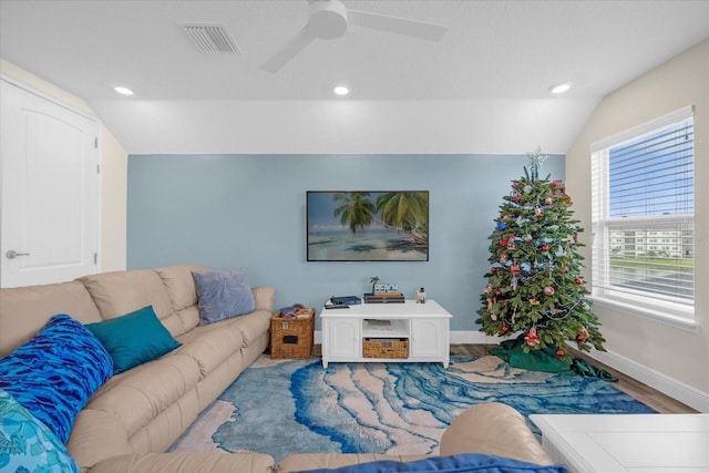 living room with light hardwood / wood-style flooring, vaulted ceiling, and ceiling fan