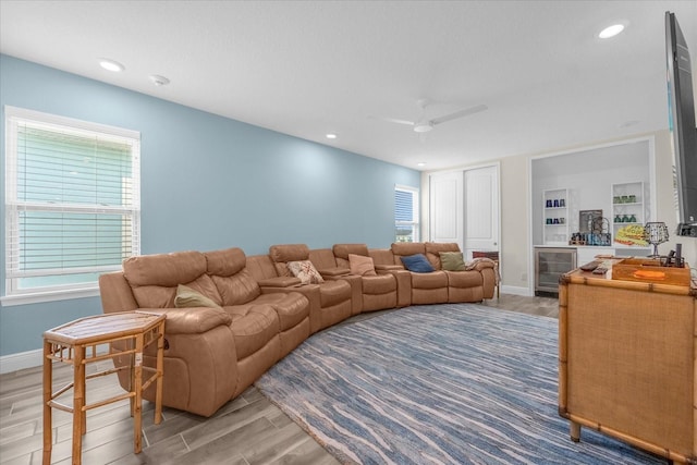 living room with wine cooler, ceiling fan, and built in features