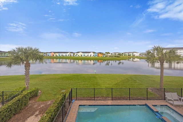 view of pool featuring a yard and a water view