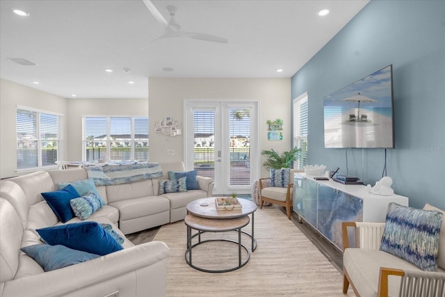 living room with light hardwood / wood-style flooring and ceiling fan