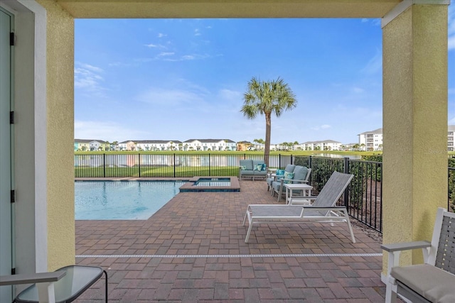 view of patio / terrace featuring an outdoor living space, a water view, and a pool with hot tub