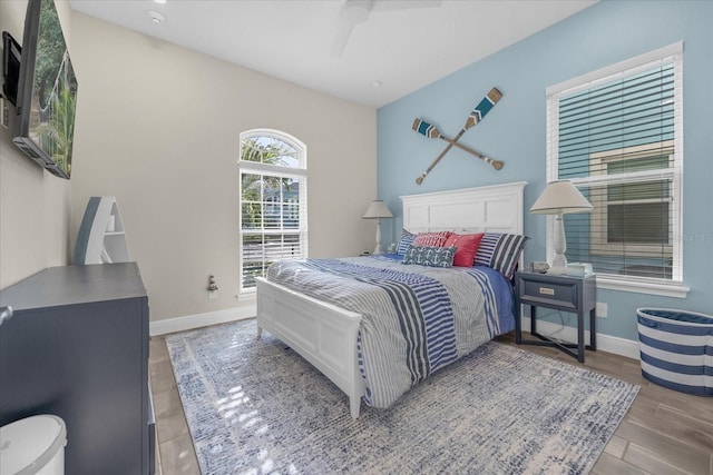 bedroom with hardwood / wood-style floors and ceiling fan