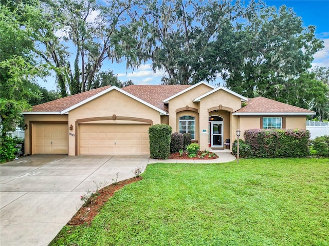 ranch-style home with a front yard and a garage