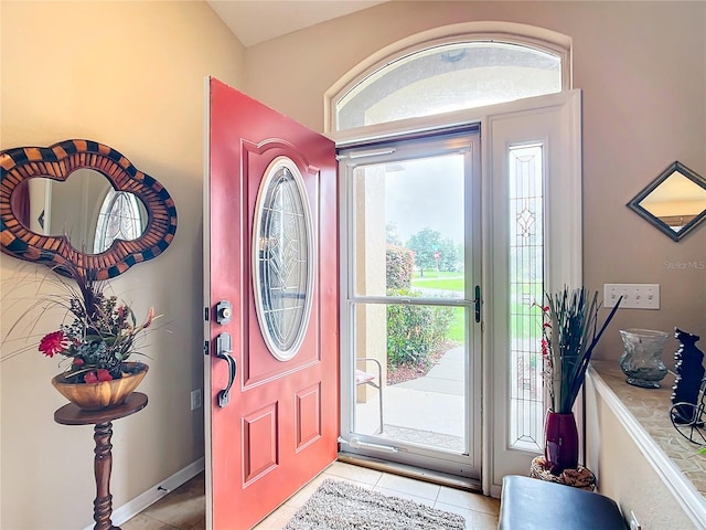 foyer featuring plenty of natural light and light tile patterned floors