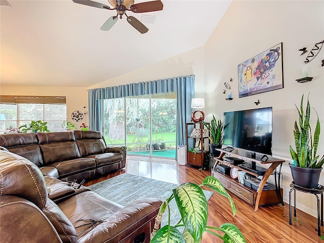 living room with ceiling fan, lofted ceiling, and light hardwood / wood-style floors