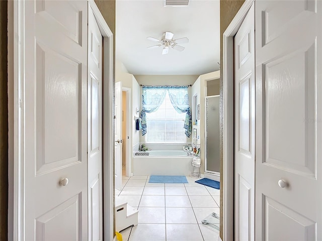 bathroom with ceiling fan, separate shower and tub, and tile patterned flooring