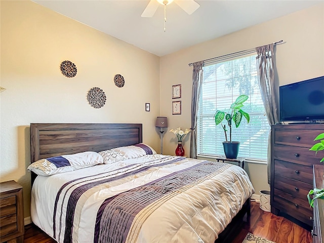 bedroom featuring ceiling fan and dark hardwood / wood-style floors