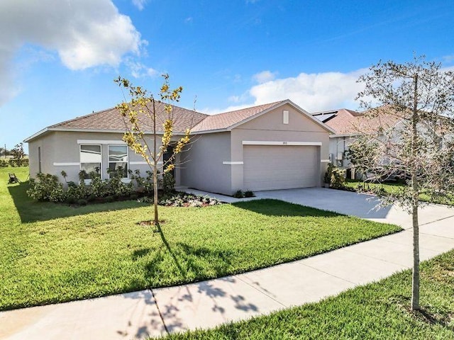 single story home featuring a garage and a front lawn