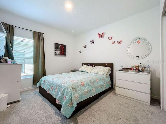 bedroom featuring light colored carpet