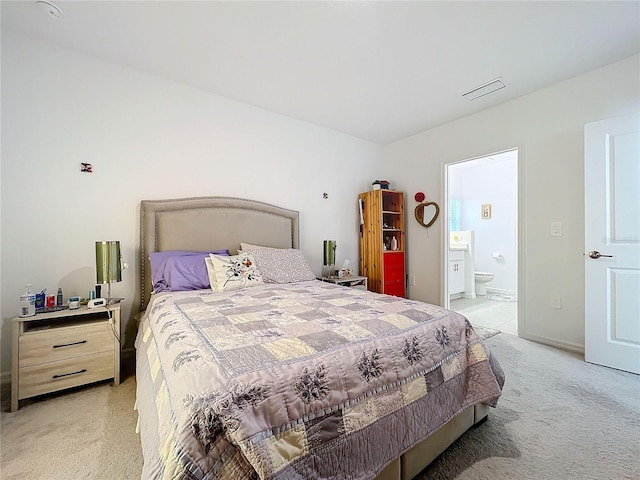 carpeted bedroom with ensuite bath