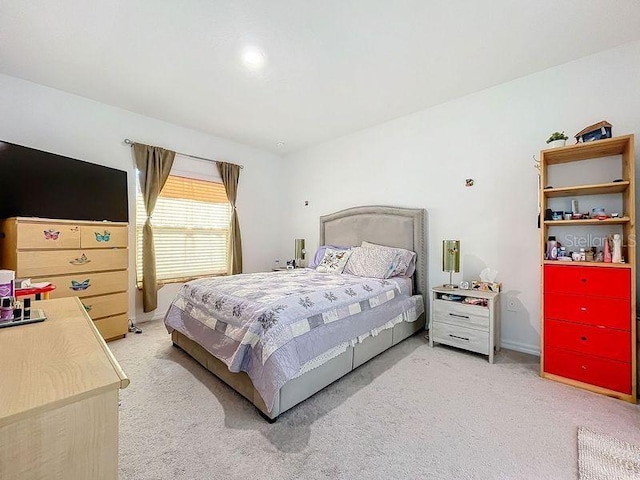 bedroom featuring light carpet