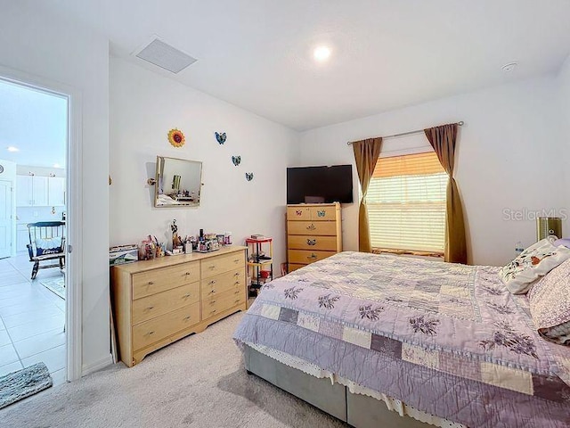 bedroom featuring light colored carpet