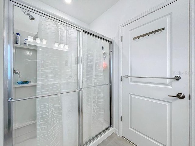 bathroom with a shower with door