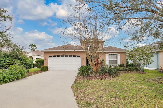 single story home featuring a front lawn and a garage