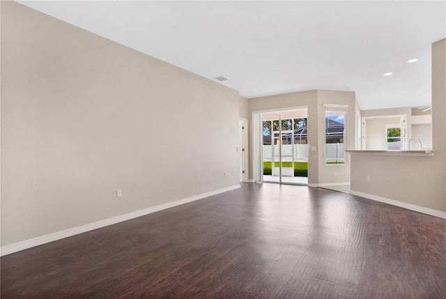 unfurnished living room featuring dark hardwood / wood-style flooring