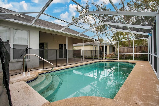 view of swimming pool with a patio and a lanai