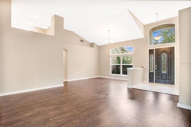 entryway with an inviting chandelier, dark hardwood / wood-style floors, and high vaulted ceiling