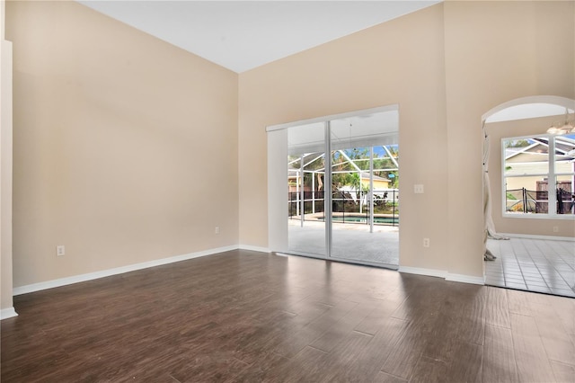 empty room featuring dark hardwood / wood-style floors and a healthy amount of sunlight