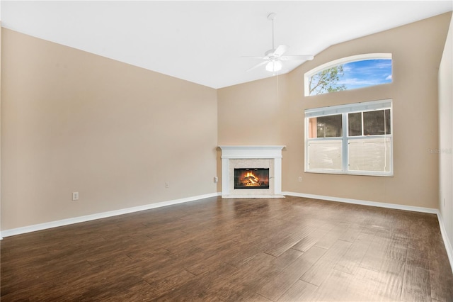 unfurnished living room featuring ceiling fan, lofted ceiling, and dark hardwood / wood-style floors