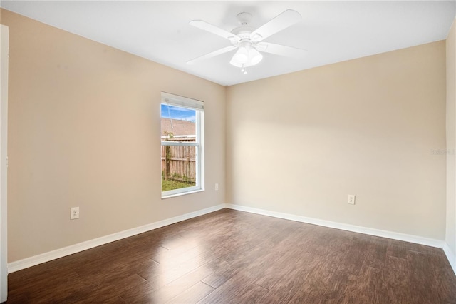 empty room with dark wood-type flooring and ceiling fan