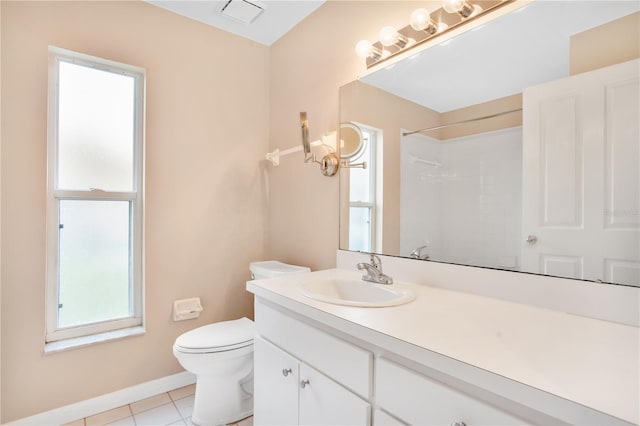 bathroom with toilet, vanity, a shower, and tile patterned flooring