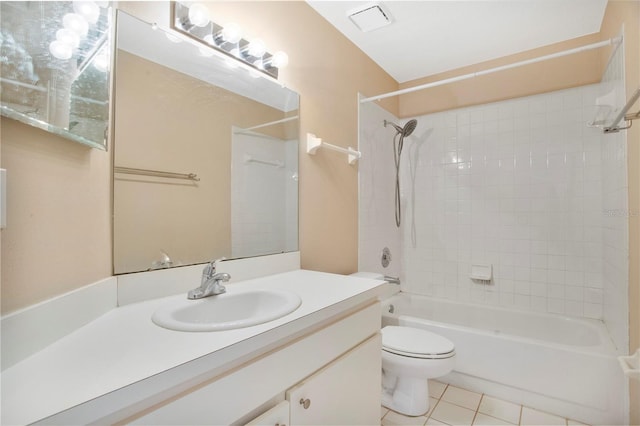 full bathroom featuring tiled shower / bath, vanity, toilet, and tile patterned floors