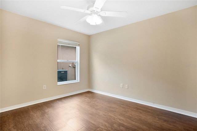 empty room featuring ceiling fan and dark hardwood / wood-style flooring